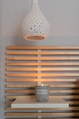 a candle sitting on a table under a light fixture at 12 Keys Athens Apartments in Athens