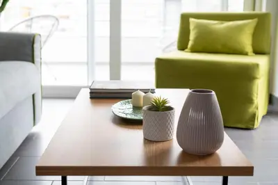 a coffee table in a living room with a green couch at 12 Keys Athens Apartments in Athens
