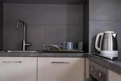 a kitchen counter with a sink and a coffee maker at 12 Keys Athens Apartments in Athens
