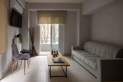a living room with a couch and a table at 12 Keys Athens Apartments in Athens