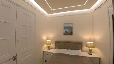a bedroom with a bed and two lamps on a nightstand at ATHENS City Center Historical Area in Athens