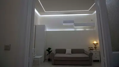 a living room with a couch and a light at ATHENS City Center Historical Area in Athens