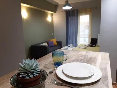 a table with a plate and a glass on it at Renovated apartment close to Exarchia square in Athens