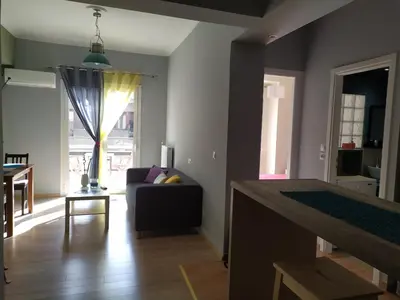 a living room with a couch and a table at Renovated apartment close to Exarchia square in Athens