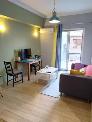 a living room with a couch and a table at Renovated apartment close to Exarchia square in Athens