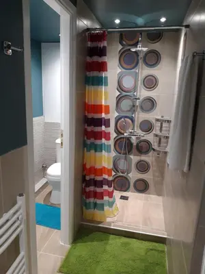 a bathroom with a shower with a colorful shower curtain at Renovated apartment close to Exarchia square in Athens