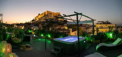 a backyard with a jacuzzi tub on a patio at Plaka Arch Suites in Athens