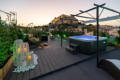 a deck with a hot tub and a playground at Plaka Arch Suites in Athens