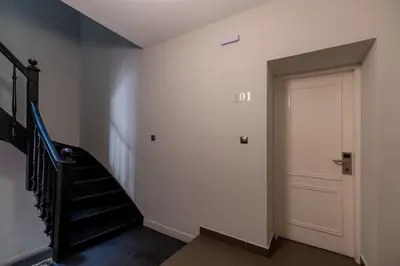 a hallway with a stair case and a door at Plaka Arch Suites in Athens