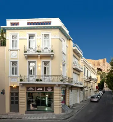 a building on the side of a street with cars at Plaka Arch Suites in Athens