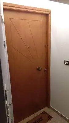 a wooden door in a room with a floor at Lemontree in Athens