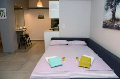 a bed with two pillows on it in a room at Olive Tree Deluxe Apt under Acropolis in Athens