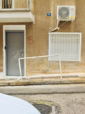 a building with a air conditioner on the side of it at Olive Tree Deluxe Apt under Acropolis in Athens