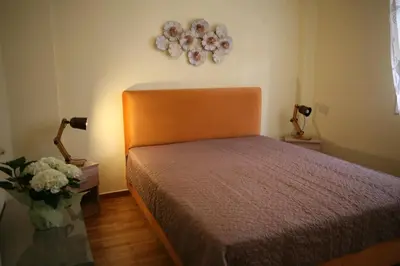 a bedroom with a bed and a vase of flowers at Marika Apartment in Athens