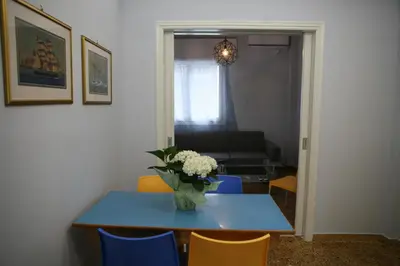 a dining room table with a vase of flowers on it at Marika Apartment in Athens