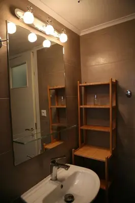 a bathroom with a sink and a mirror at Marika Apartment in Athens
