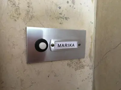 a switch on a wall with the word maria at Marika Apartment in Athens