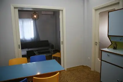 a room with a blue table and chairs and a room at Marika Apartment in Athens