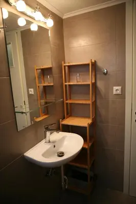 a bathroom with a sink and a mirror at Marika Apartment in Athens