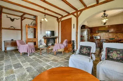 a living room with pink chairs and a fireplace at Light-filled home with Garden near Beach in Anavissos