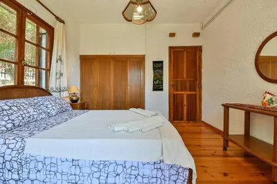 a bedroom with a bed with two towels on it at Light-filled home with Garden near Beach in Anavissos