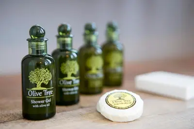 a group of four bottles of olive tree sauce oil and a tablespoon at One Three One - In the Heart of Athens in Athens