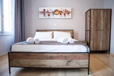 a bedroom with a bed with towels on it at One Three One - In the Heart of Athens in Athens