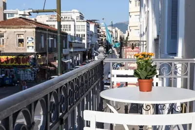 a table with a flower pot on it on a balcony at One Three One - In the Heart of Athens in Athens