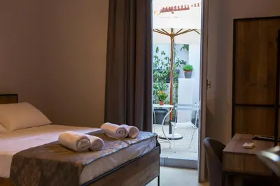 a hotel room with a bed with towels on it at One Three One - In the Heart of Athens in Athens