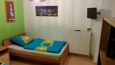 a small bedroom with a bed with blue pillows at Luxury Apartment in Ano Glyfada in Athens