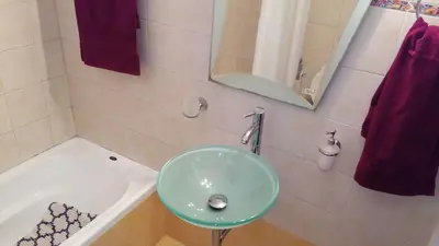 a bathroom with a green sink and a tub at Luxury Apartment in Ano Glyfada in Athens