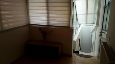 a hallway with a window and a plant in a vase at Luxury Apartment in Ano Glyfada in Athens