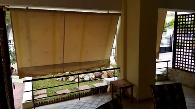 a window with a curtain in a room at Luxury Apartment in Ano Glyfada in Athens