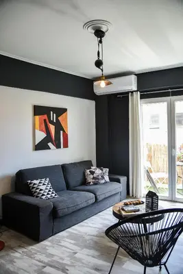 a living room with a blue couch and a table at Home Plus Psirri Apartment in Athens