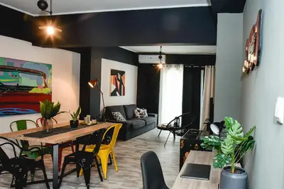 a living room with a table and a couch at Home Plus Psirri Apartment in Athens