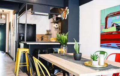 a dining room with a wooden table and yellow chairs at Home Plus Psirri Apartment in Athens