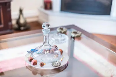 a glass bottle on a table with balls in it at Athenian house of 1920 in Athens