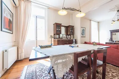 a living room with a table and a couch at Athenian house of 1920 in Athens