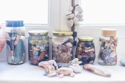 a group of jars filled with different types of rocks at Athenian house of 1920 in Athens