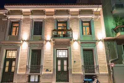 a building with a bunch of windows and doors at Athenian house of 1920 in Athens
