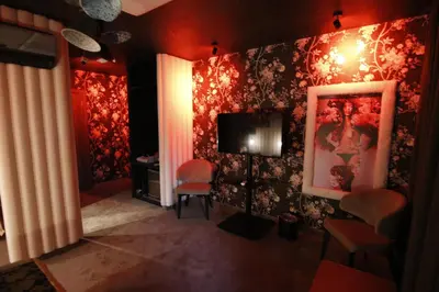 a living room with red walls and a television at Madison in Athens