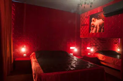 a red bedroom with two beds with red lights at Madison in Athens
