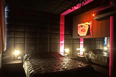 a room with a bed in a room with lights at Madison in Athens