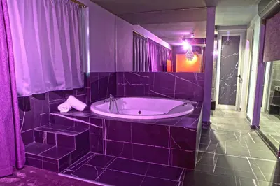 a purple bathroom with a tub and a sink at Madison in Athens
