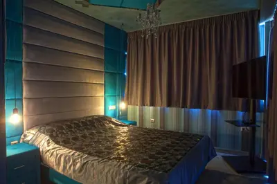 a bedroom with a bed and a chandelier at Madison in Athens