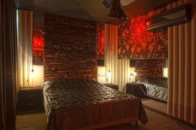 a bedroom with two beds and a brick wall at Madison in Athens
