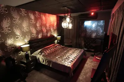 a bedroom with a bed and a red wall at Madison in Athens