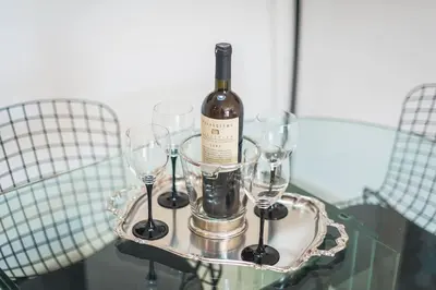 a bottle of wine on a table with wine glasses at Seaside Central Apartment in Athens