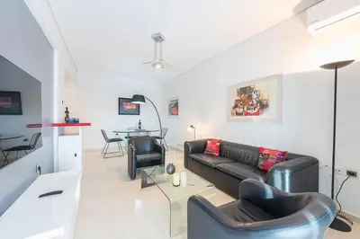 a living room with a couch and a table at Seaside Central Apartment in Athens
