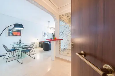a door to a room with a table and chairs at Seaside Central Apartment in Athens
